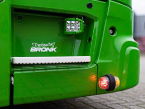 Danish LED side lamp orange - red with transparent glass - mounted in the front bumper of a Scania Next Gen