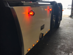 Danish side lamp with Gylle lens ORANGE - mounted with mounting base on side skirt Scania - EAN: 7392847307866